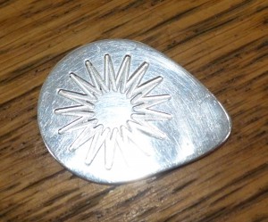 Silver guitar pick with 17 pt star cut by Modela machine.