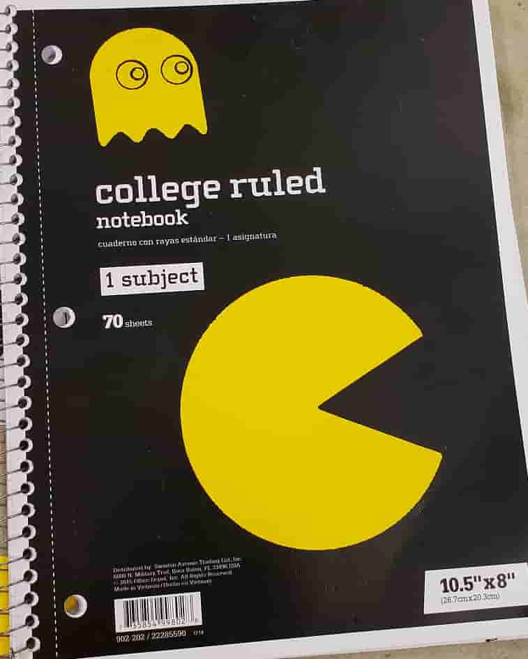 A yellow pacman and yellow ghost on a black notebook