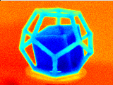 Looping image of a rotating cube inside a dodecahedron frame going from a deeper to a lighter shade of blue