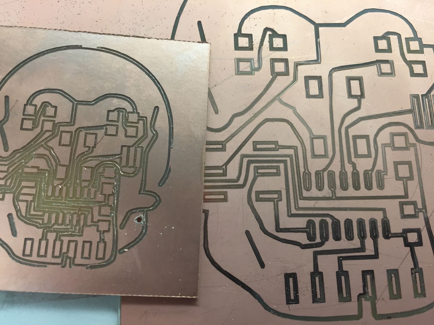 Two copper circuit boards designed to look like a scull