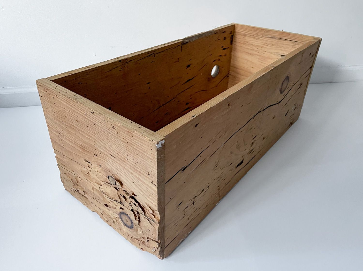 Rectangular wooden crate against a white background