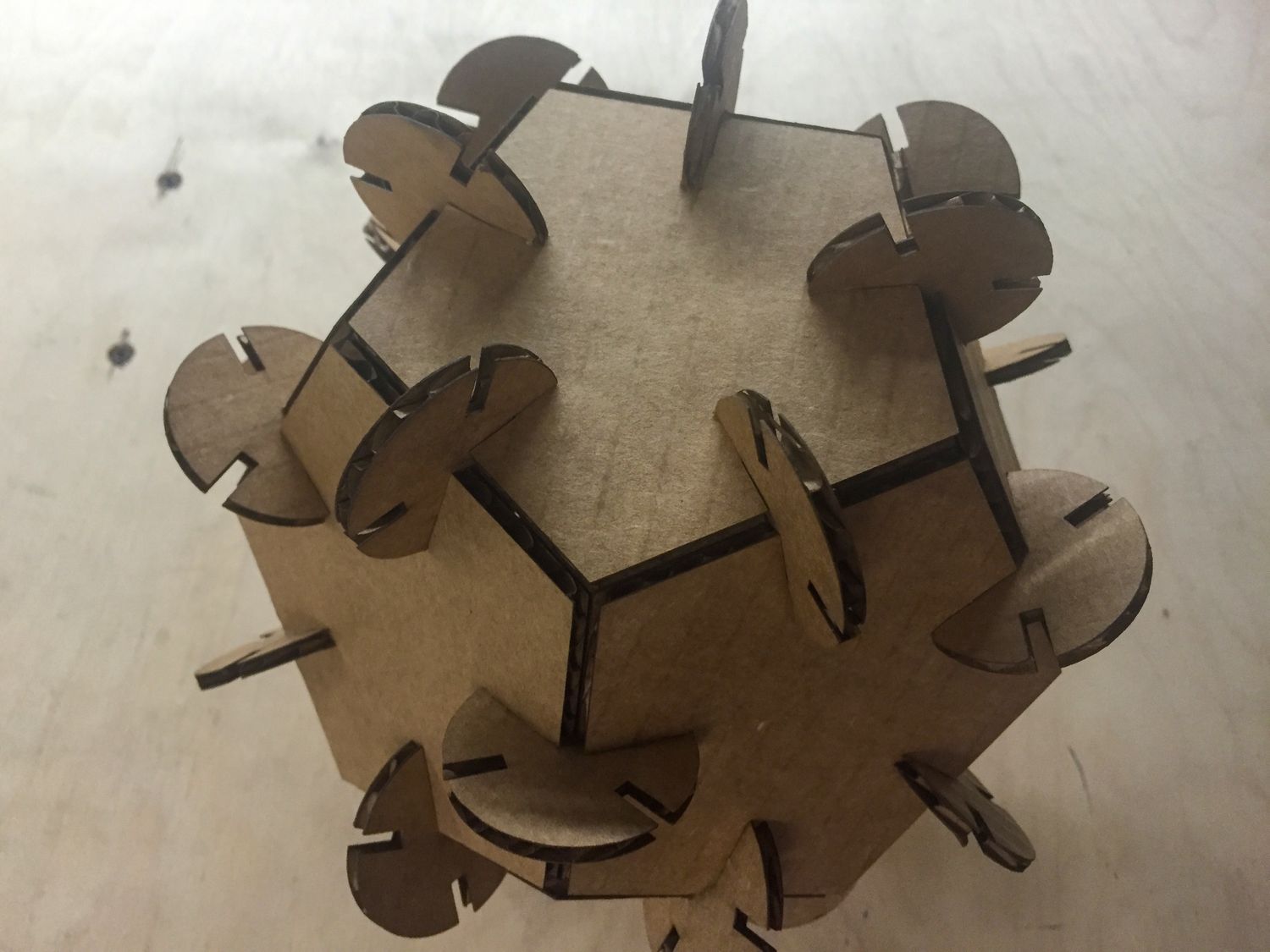 Cardboard dodecahedron on a wooden background