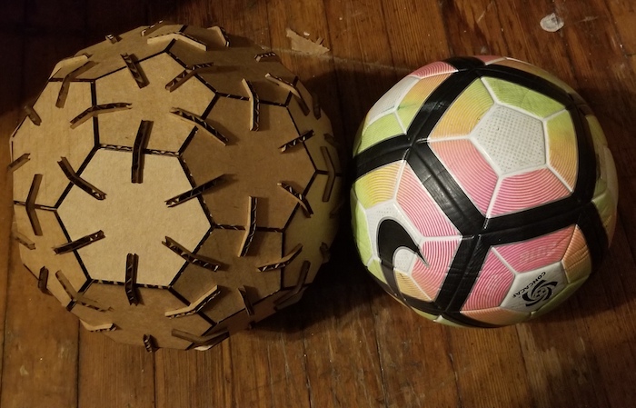Laser cut and real soccer ball side by side.