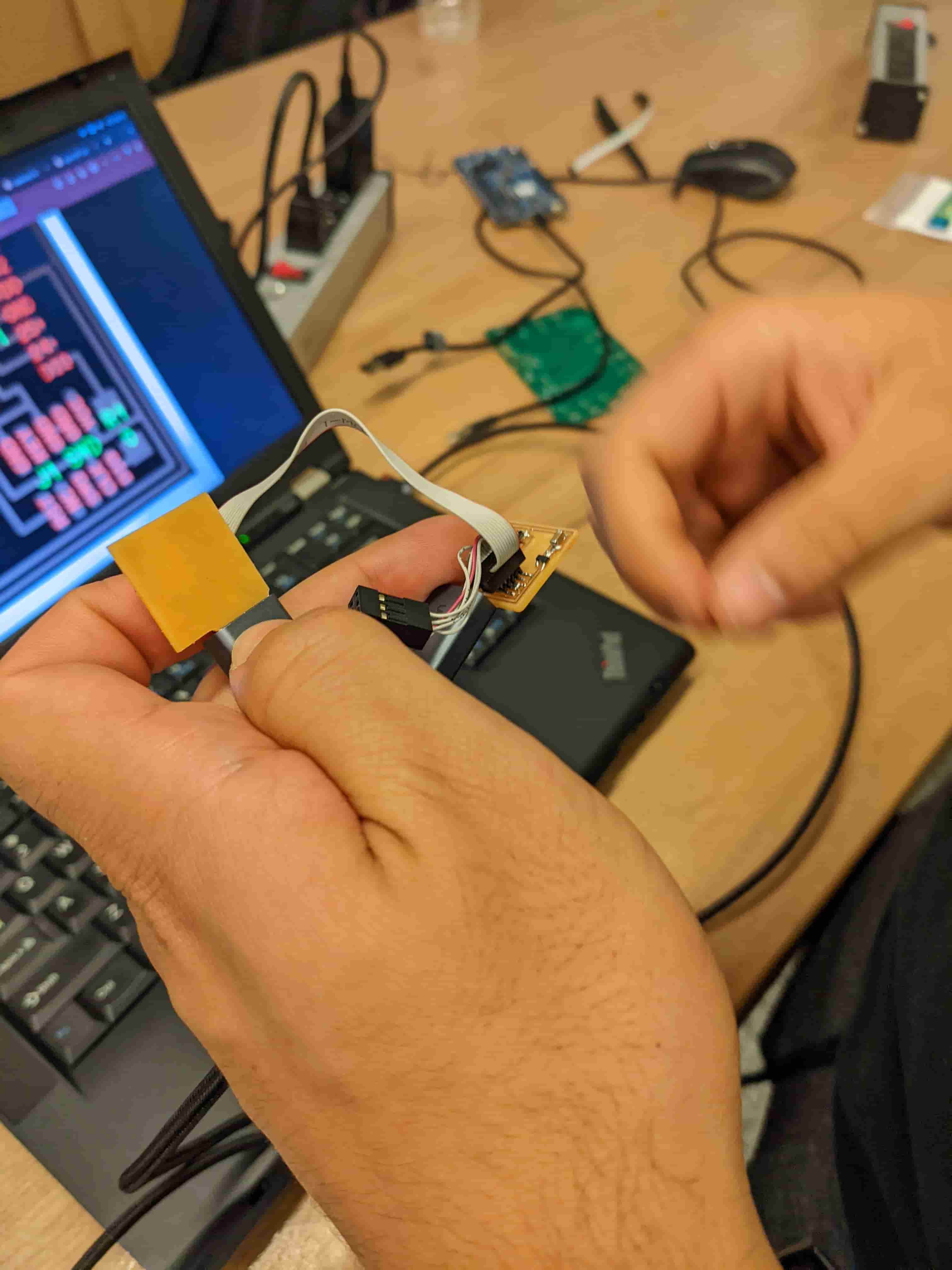 Me programming my board with my friend's board that I just programmed