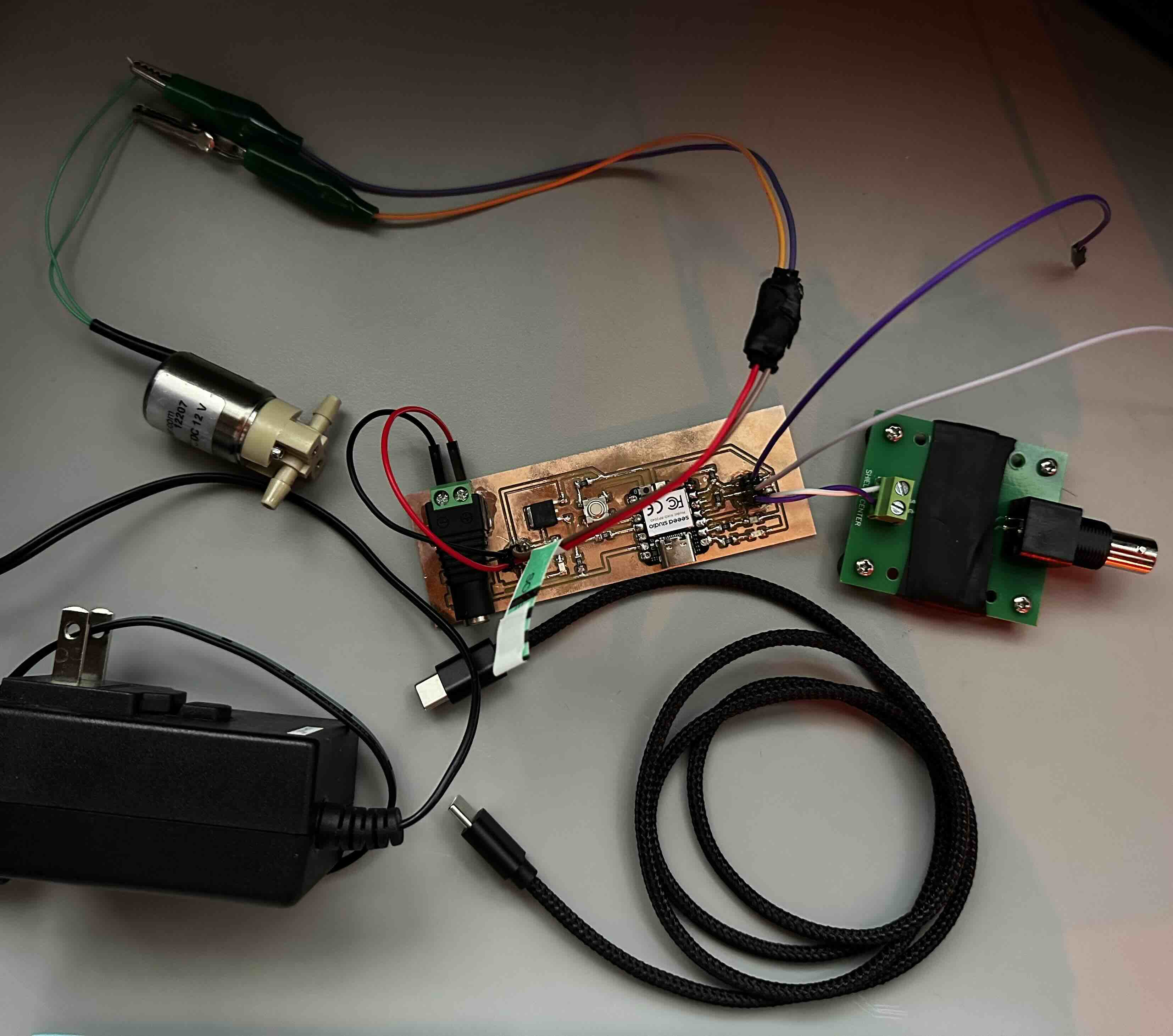 Board after soldering components on. I checked all my soldering joints with the multimeter continuity mode, then super glued the surface mount headers onto the board for stability. Similarly, I needed to replace my surface mount power jack with a screw terminal power jack which was super glued onto clear space on the board.