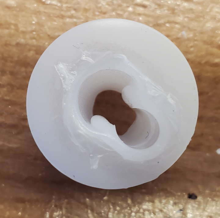 Plastic piece that goes with the spindle motor, melted