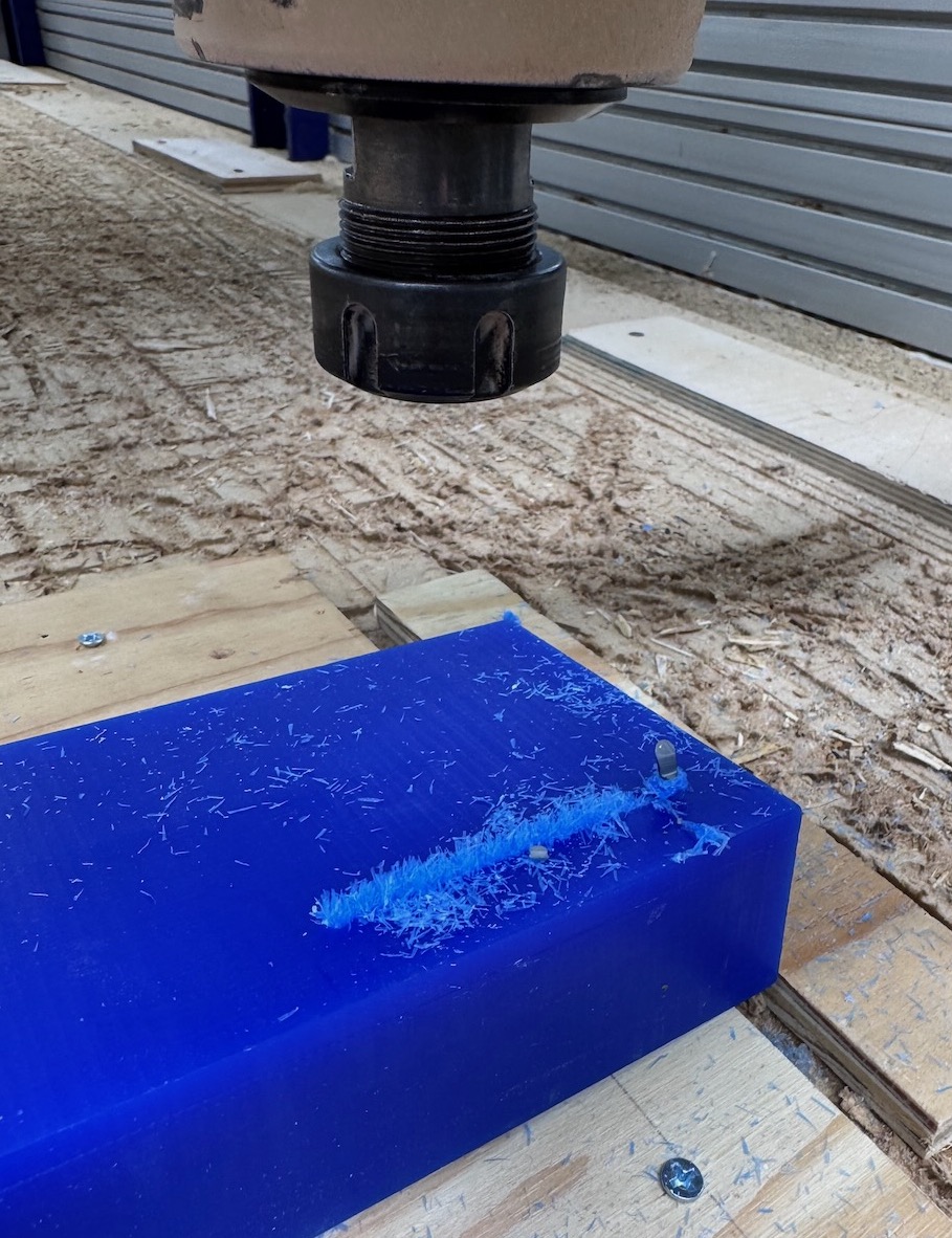 Broken endmill bit due to workholding failure.