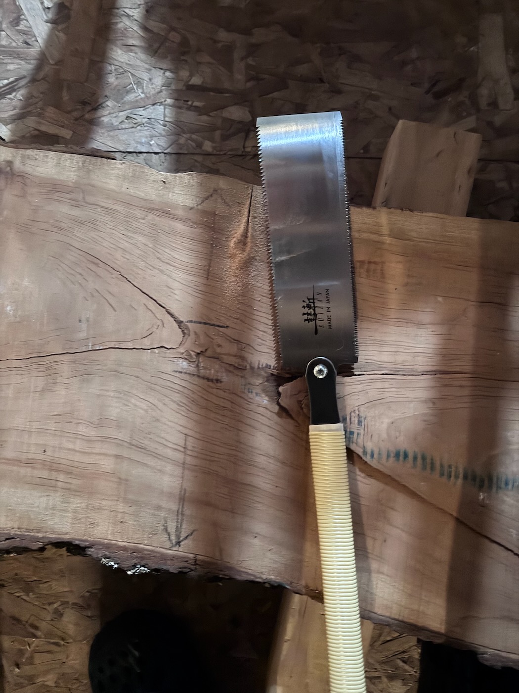 Cutting the slab in half with a Japanese-style pull saw.