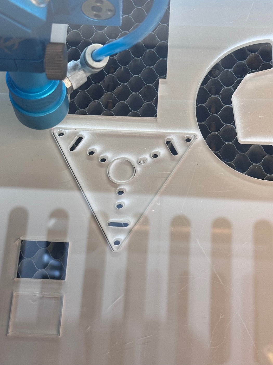 Laser cutting acrylic triangle panel.