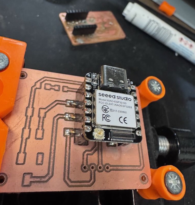 Soldering the XIAO ESP32S3 into the male header pins.