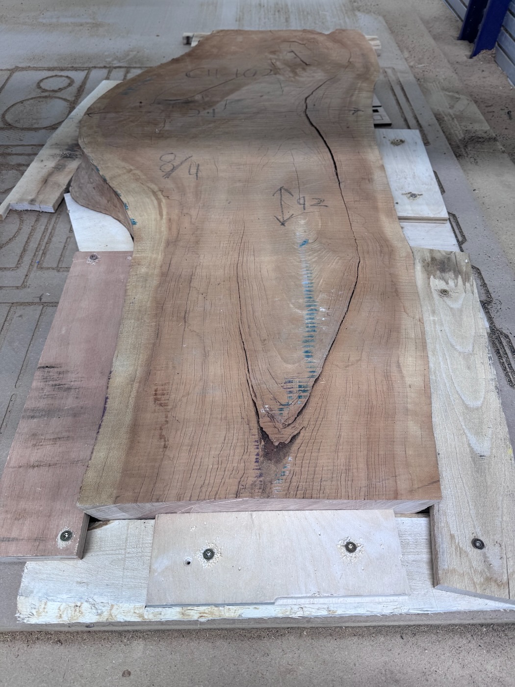 Workholding with scrap wood secured by wood screws.