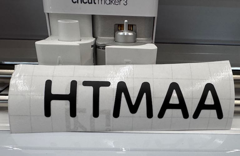 Image of HTMAA sticker on transfer tape.