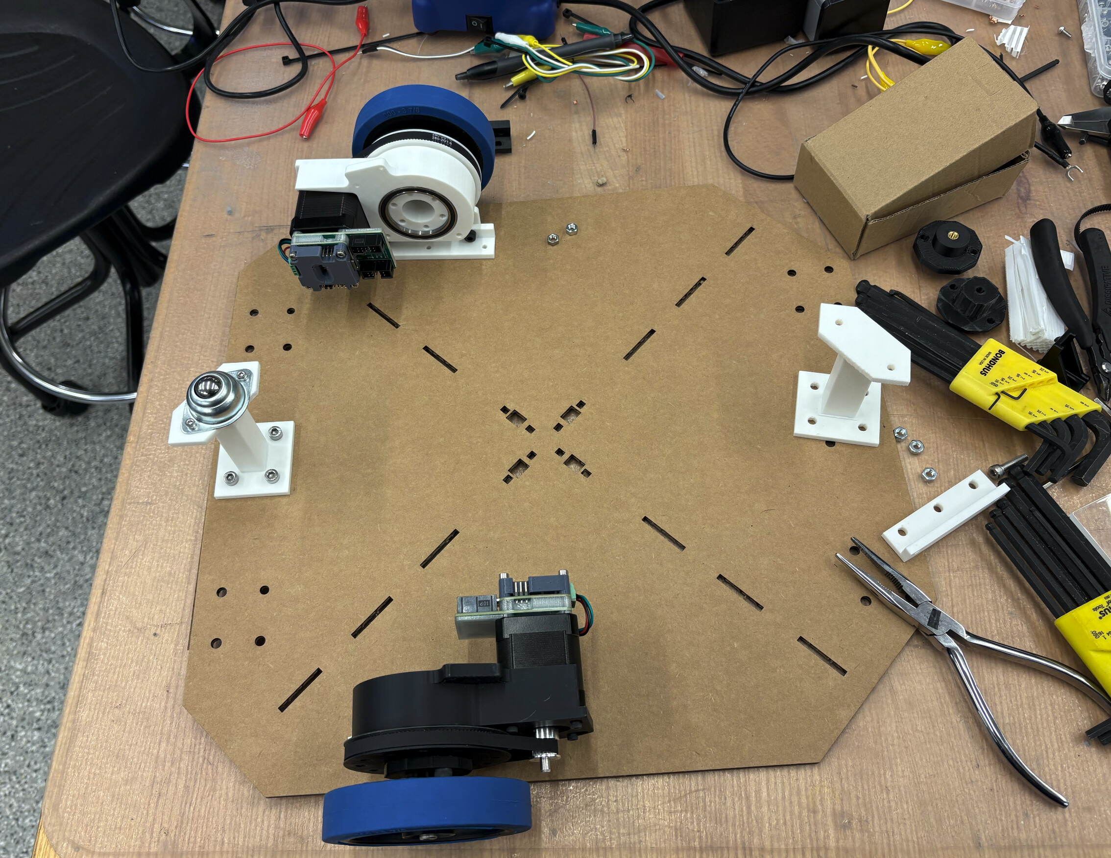 Drive base parts and wheel modules laid out during assembly
