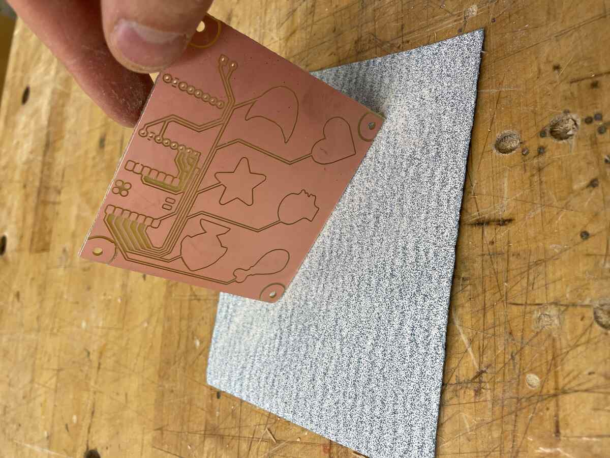 Sanding the board down by hand