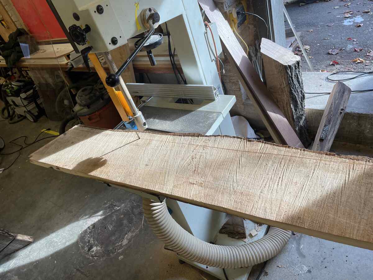Bandsawing the bark from the plank