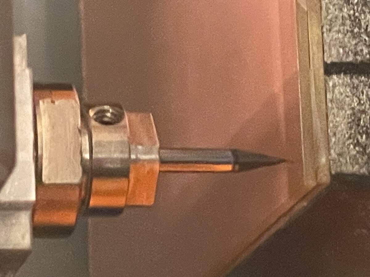 You press the bit gently down into the board and tighten the hex at the top to set it to the right height