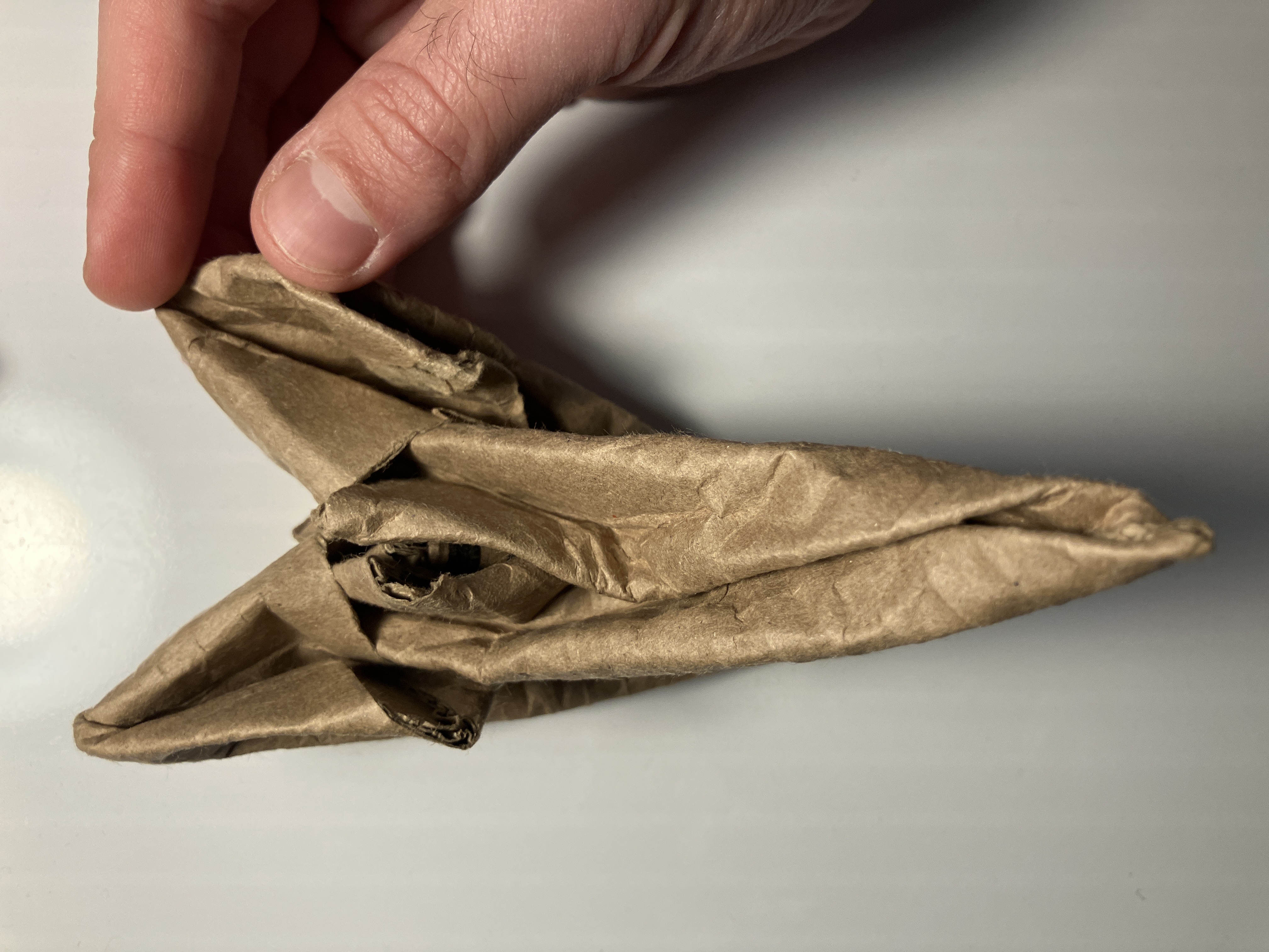 Insertion detail during assembly of hand‑folded double gadget