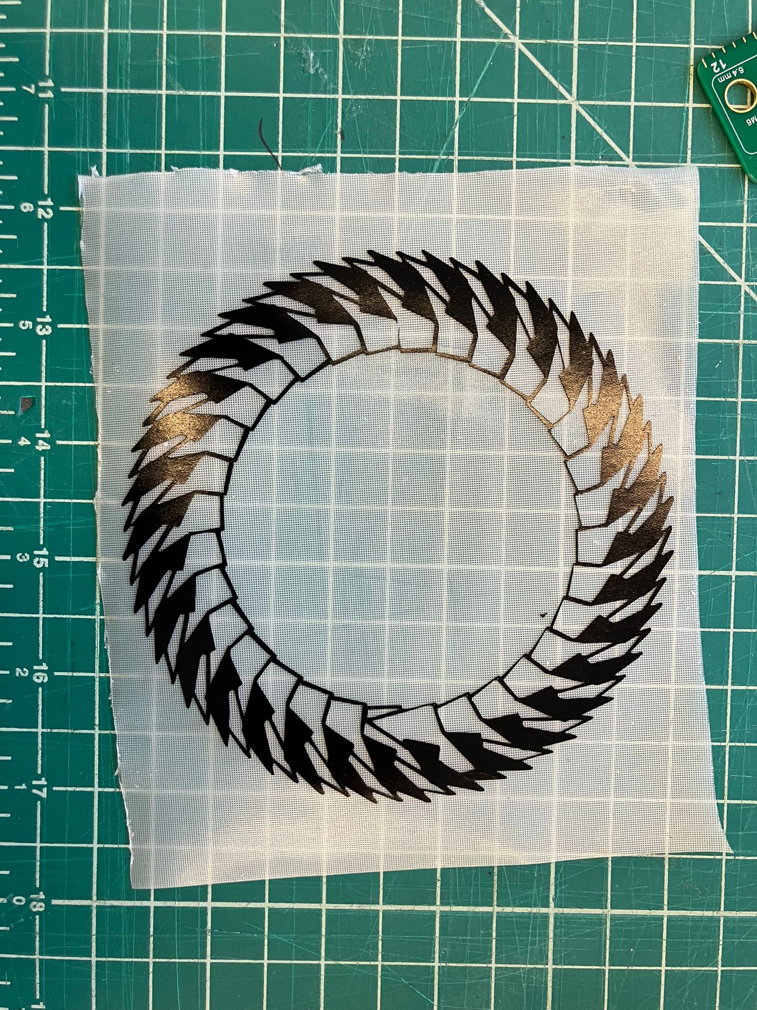 Removing transfer paper to reveal vinyl design