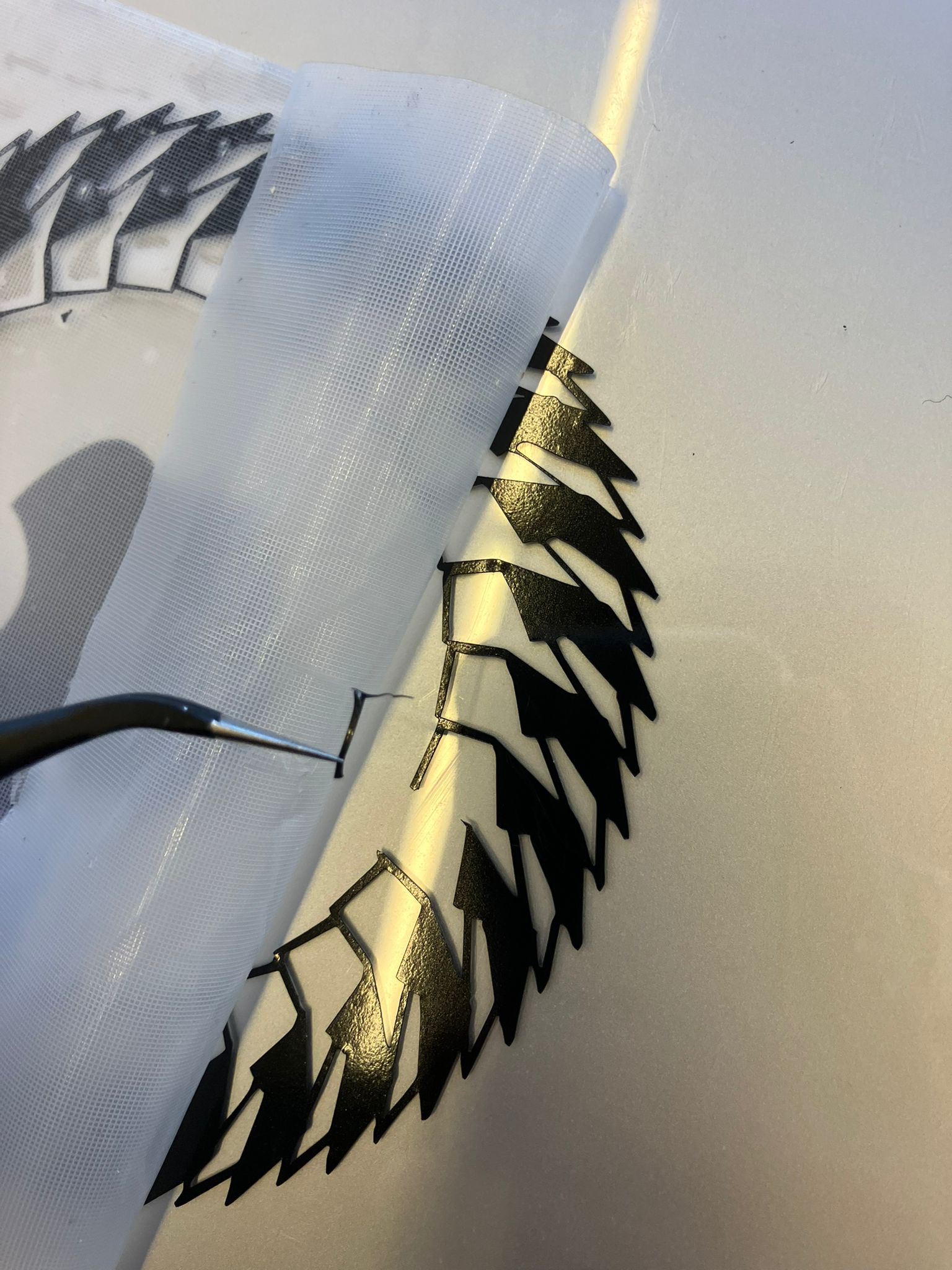 Using tweezers to remove vinyl backing