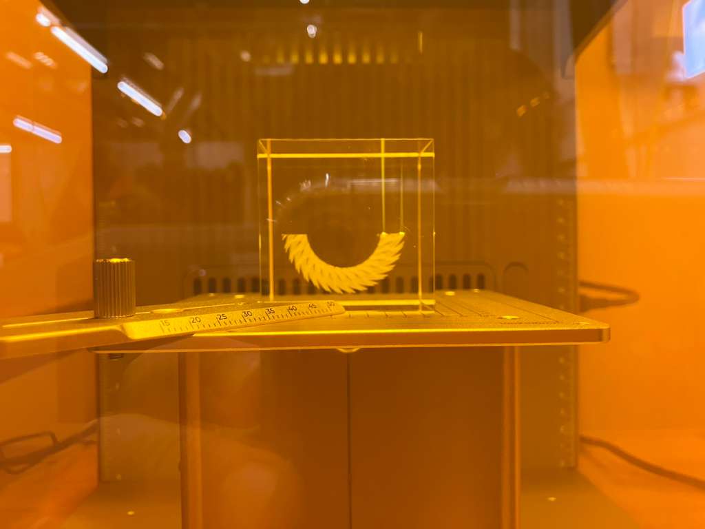 Glass piece halfway through engraving process