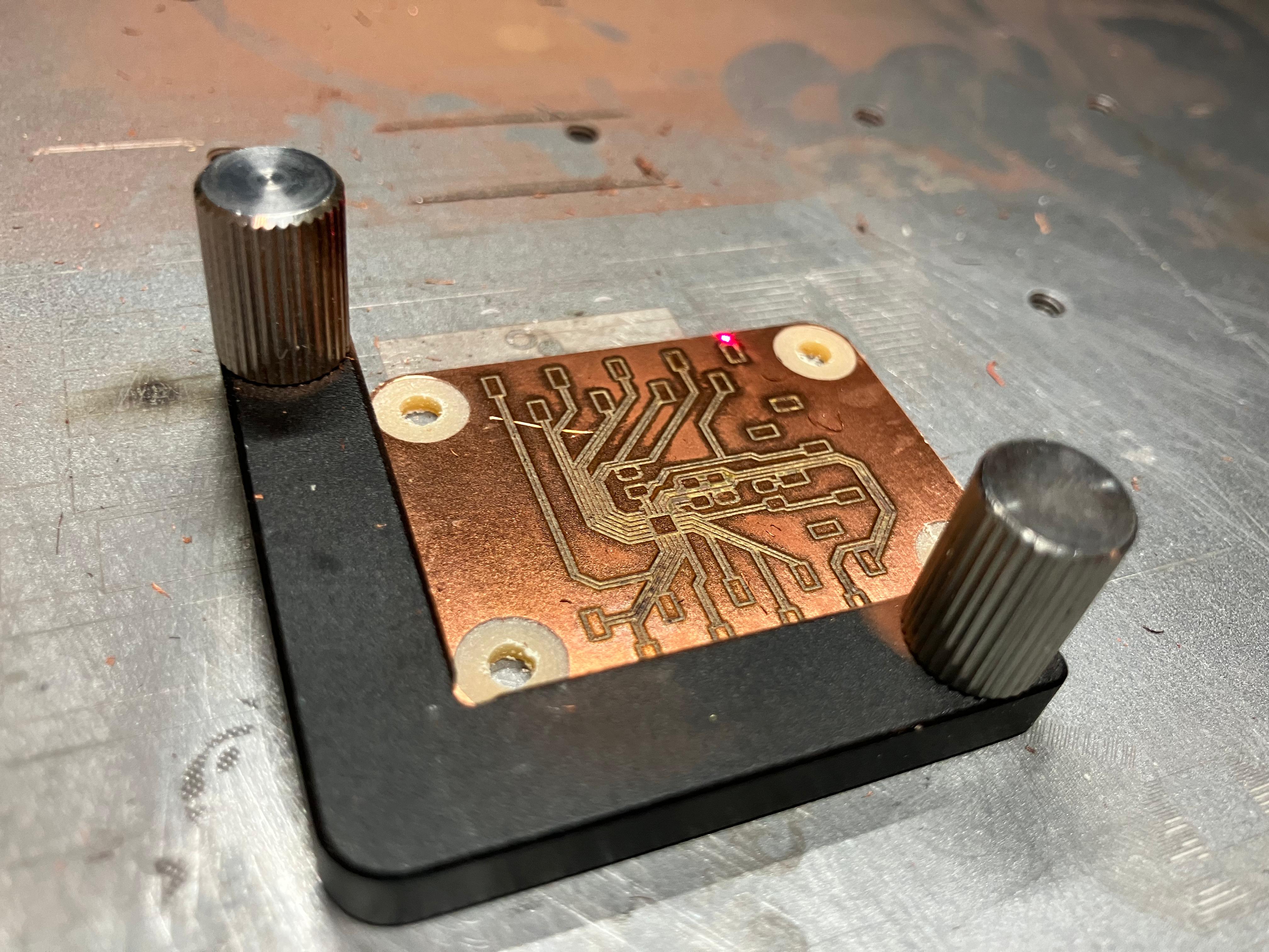PCB fixtured during engraving process