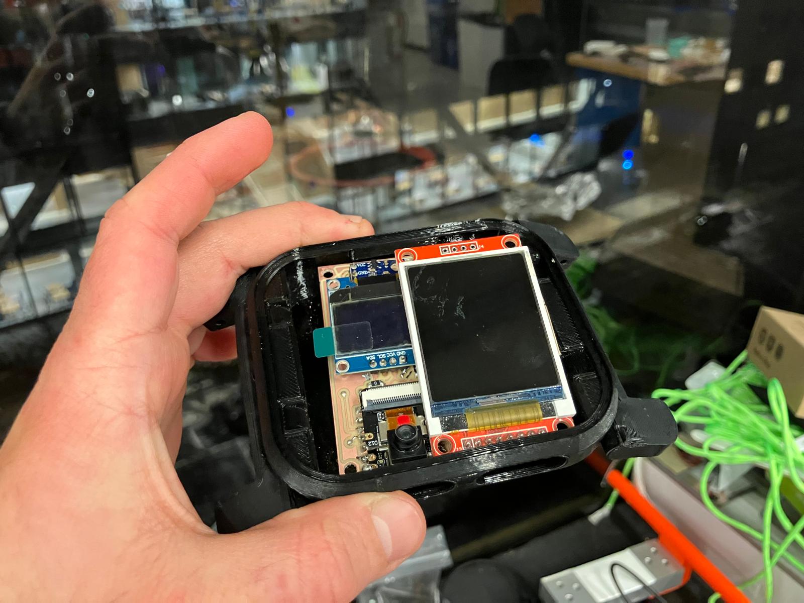 Aging clock board test-fitted inside the open watch enclosure