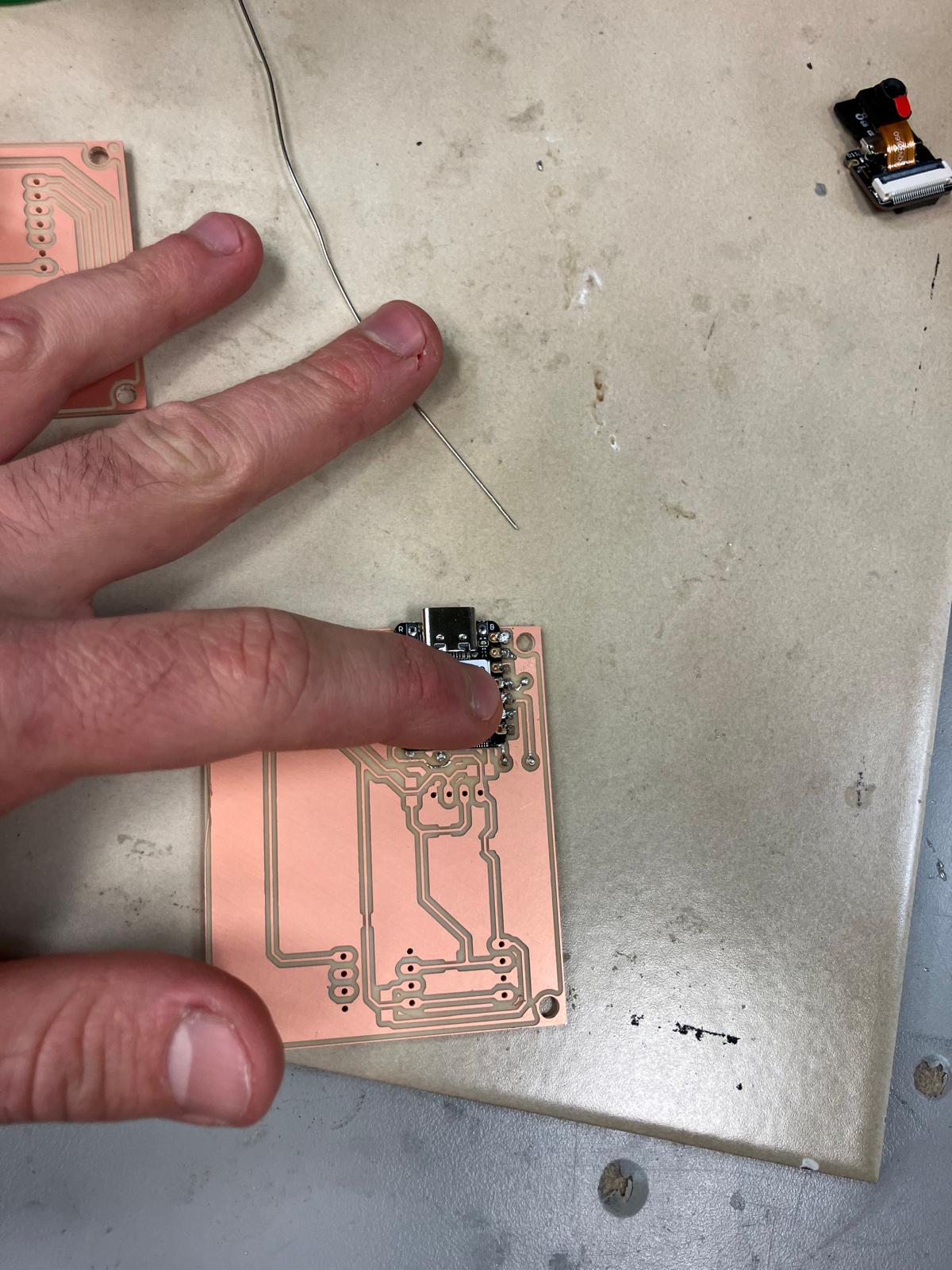 Microcontroller soldered flat above rivets using the tape-assisted method