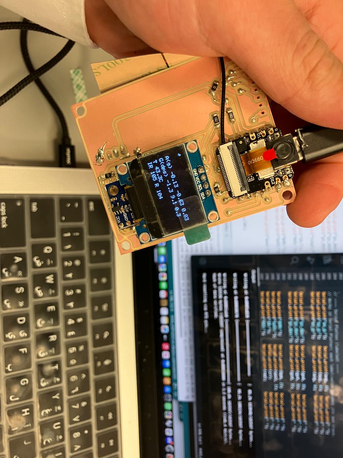OLED display showing text output from the aging clock firmware