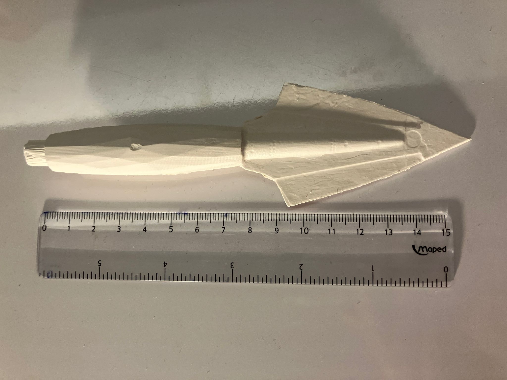 Final Kryptonite arrow measured against a ruler