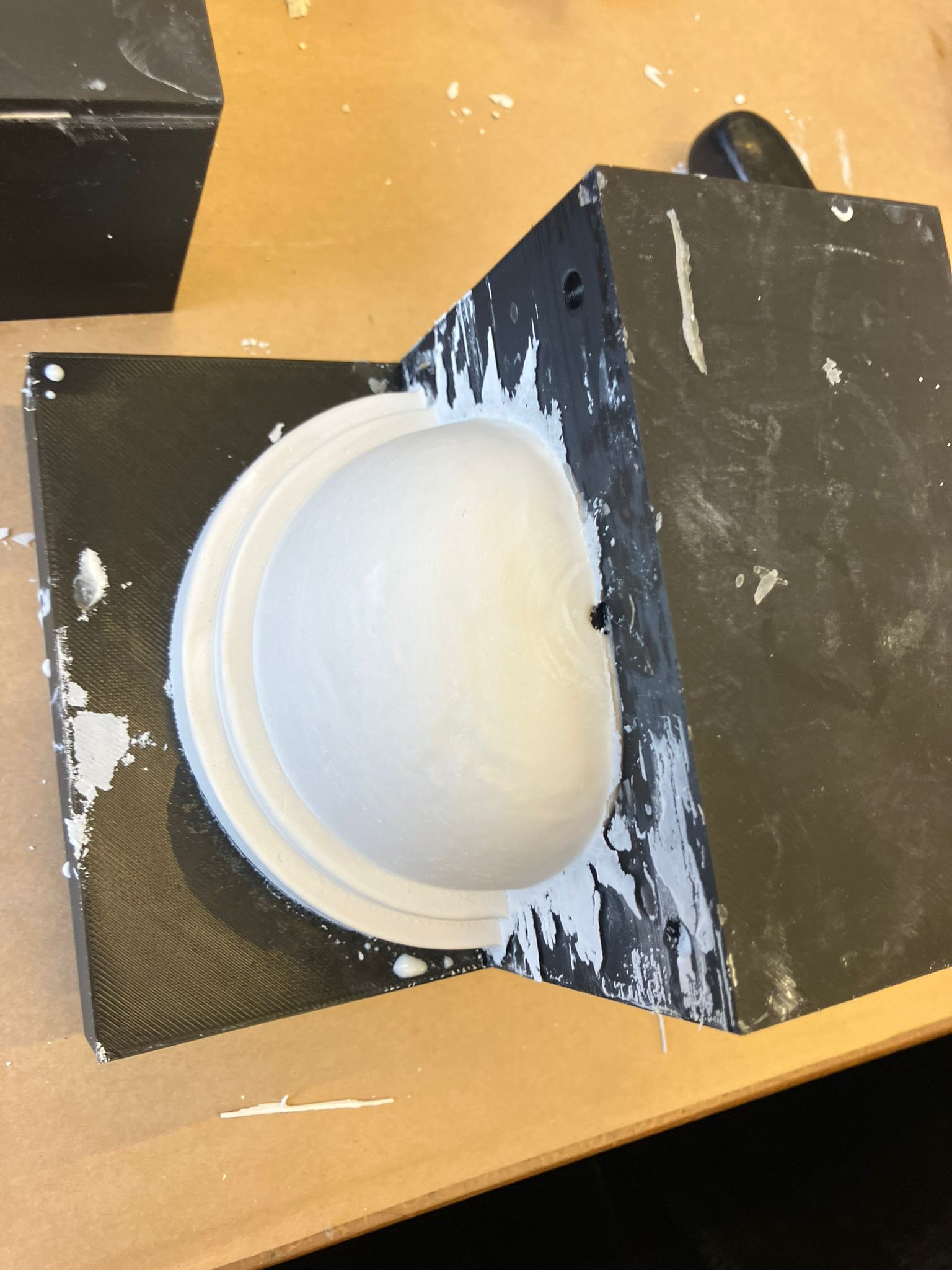 Putty knife working under the base dome mold flange