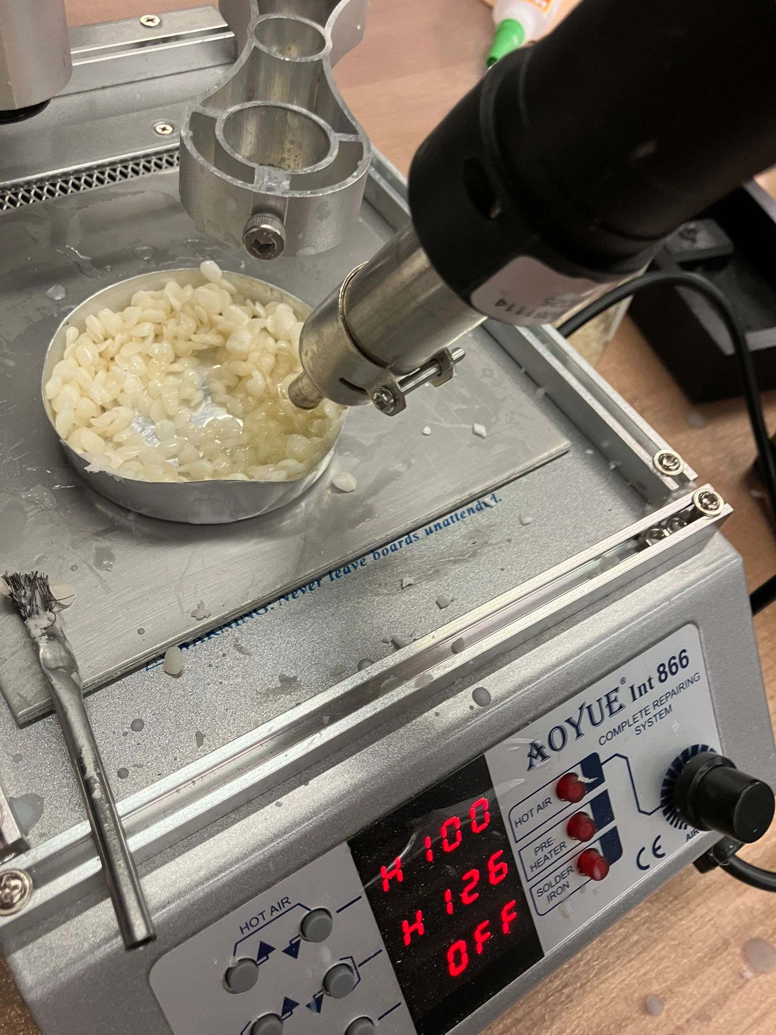 Beeswax pellets melting in a metal pot