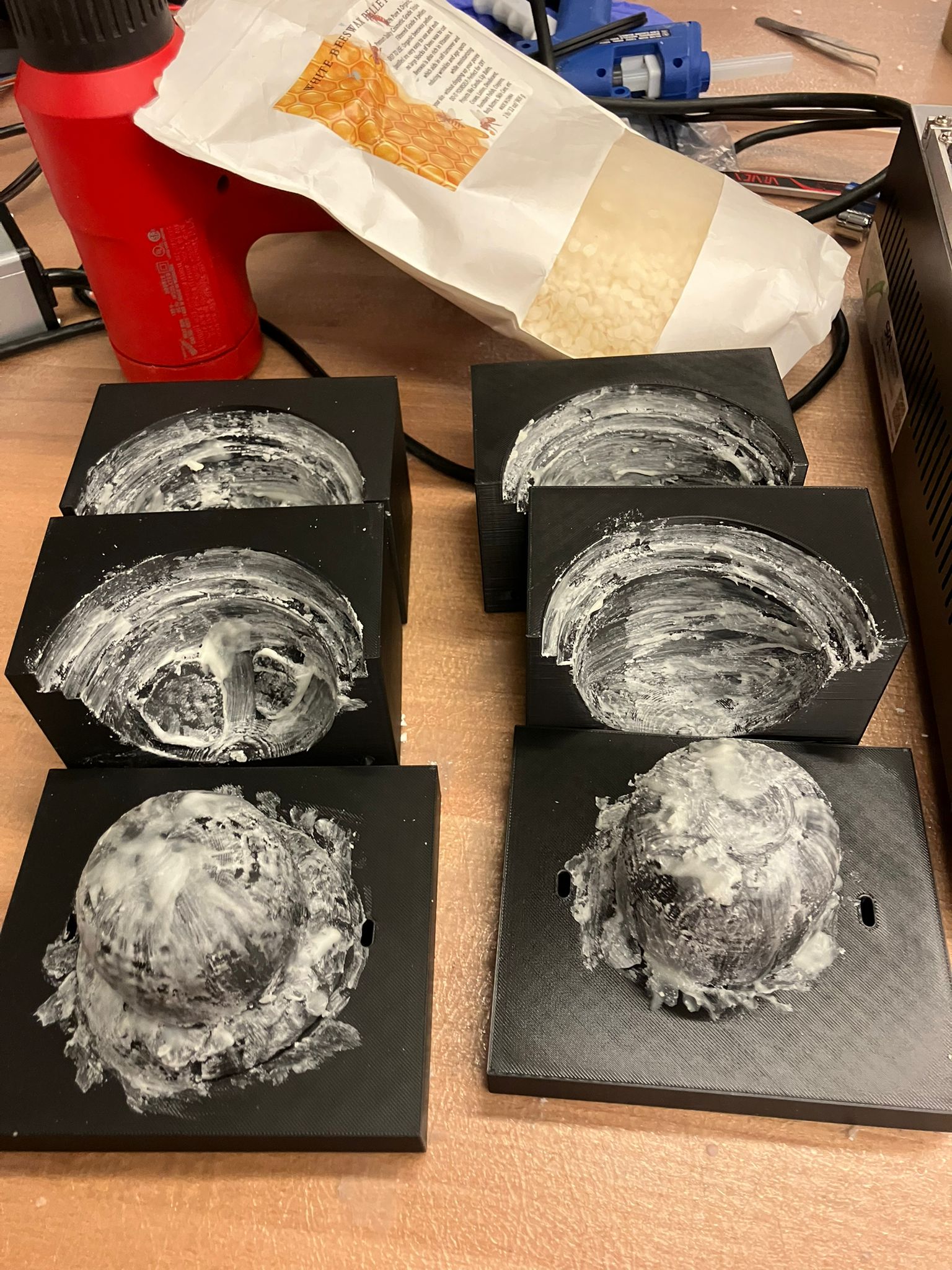 Melted beeswax pooled in heating vessel