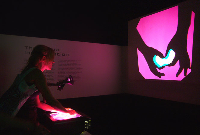 Dark exhibition with projection and hands
