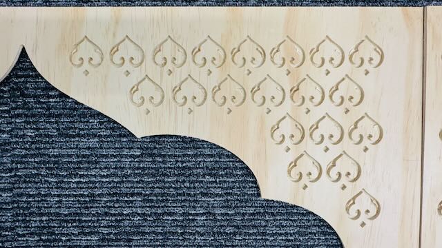 Close-up view of the CNC-cut arch pattern showing precision and surface finish