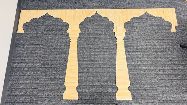 Completed installation showing CNC-cut arch panels mounted on antique carved pillars