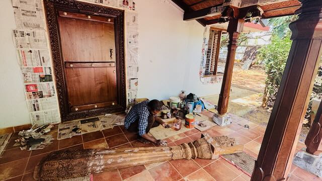 Sitting area with 150-year-old carved wooden door leading to bedroom