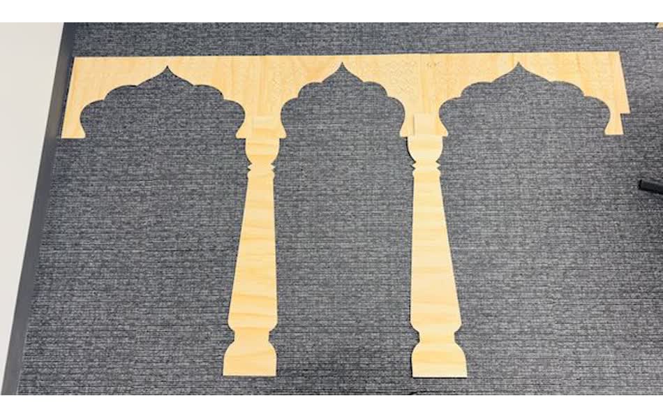 Prototype CNC-cut arch panel shown with antique carved pillars