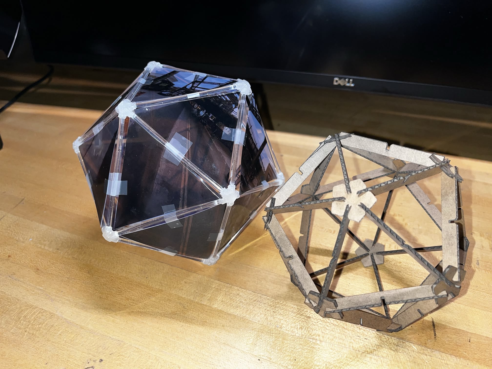 Fully assembled icosahedron kit side by side with the original lightbox prototype