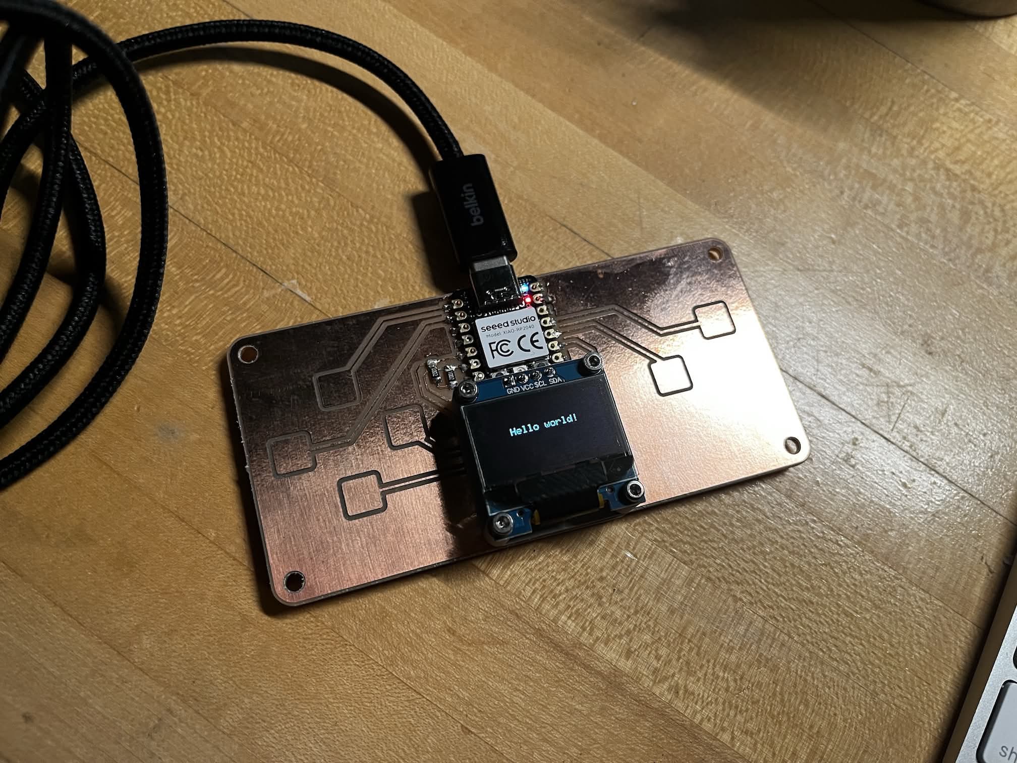 The Seeed Studio XIAO RP2040 board, came with a "Hello" message on the OLED display